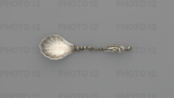 Decorative silver spoon with a shell-shaped scoop and handle formed by a solid dolphin supporting a naked woman who covers her breasts with her left hand and holds a shawl to cover her womb with her right; decorated with Venus and dolphin motifs; maker: François-Auguste Boyer-Callot fl. 1865– ; 4th quarter of the 19th century, Paris, France; cutlery decorative, length 8.5 cm, width 2.4 cm, weight 10 g., A metallic spoon with a scallop-shaped bowl and a decorative handle featuring a sculpted human figure and ornate twisting elements, shown against a uniform gray background; visible colors include silver tones of the spoon and various shades of gray in the background.