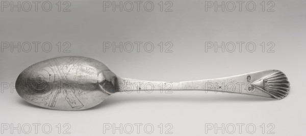 Table spoon with shooting brotherhood emblem, maker: Hermann, Christoph fl. ca. 1740–1778 goldsmith, active from the 1740s, died 1778. Silver spoon, ca. mid-18th century. On the reverse of the bowl: dotted italic inscription Anno 1766 1 April; below it an engraved shooting shield, crossed rifles, and the Elblag coat of arms. Along the handle: dotted, very faded German italic inscription Hier isst ? der Platz da zeigt deinen Fleis / Ein Edlen Rath # dir Ehr und Preis. Obverse of the handle has a later inscription: AW CH / 1860 / 14 Sept. Function: shooting-award spoon awarded at annual marksman fraternity competitions. Place: Elblag, Royal Prussia. Cutlery; length 22.5 cm; weight 64 g., A single metal spoon lies horizontally on a light gray surface, showing the bowl on the left and the handle extending to the right; the bowl has engraved concentric circular patterns and decorative engraved motifs with visible scratches and a slightly worn, reflective silver-gray finish, while the handle...