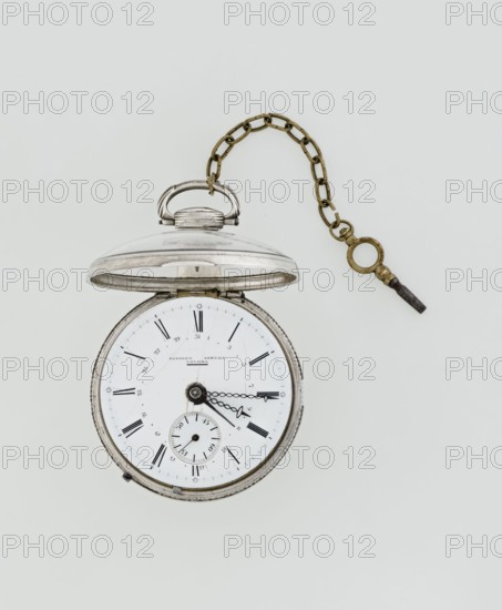Pocket watch with key, Eardley Norton fl. 1770–1792; born 1728, died 1792. Repeater pocket watch in two silver cases: smooth outer case; inner case with framed glazed lid and mechanism cover engraved with an openwork floral/acanthus twig, winding hole, and bell. White enameled dial with black Roman hour numerals, minute scale marked with dashes, calendar with Arabic numerals, three steel hands hour and minute in openwork weave; third straight for day of month. Small seconds subdial at bottom with Arabic numerals. Dial signed “EARDLEY NORTON / LONDON.” Movement: gilded brass circular plates connected by pillars, spring-powered drive, spindle escapement; lower plate with openwork crown richly decorated with acanthus tendrils and engraved acanthus volutes; cut-out reserve engraved “Eardley / Norton London.” Preserved winding key on chain. Third quarter of the 18th century; case made in Germany; movement by London maker. Timepiece. Dimensions: height 8 cm; width 6.2 cm; dial diameter 5.3 c...