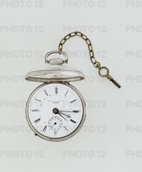 Pocket watch with key, Eardley Norton fl. 1770–1792; born 1728, died 1792, casemaker APD Germany; 3rd quarter of the 18th century. Pocket repeater in two silver cases: smooth outer case and inner case with framed glazed lid; mechanism cover engraved with an openwork floral/acanthus twig, with winding hole and bell. White enameled dial with black Roman numerals, minute scale marked with dashes, calendar with Arabic numerals, three steel hands openwork hour and minute, straight date hand. Small seconds subdial with Arabic numerals. Dial signed EARDLEY NORTON / LONDON. Gilded-brass movement with circular plates on pillars, spring-driven with spindle escapement; lower plate features an openwork crown richly decorated with acanthus tendrils and engraved acanthus volutes; cut-out reserve engraved Eardley / Norton London. Preserved winding key on chain. 3rd quarter of the 18th century. Timepiece — height 8 cm, width 6.2 cm, dial diameter 5.3 cm., A vintage pocket watch with a metal case and h...