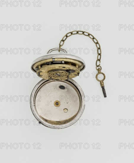Pocket watch with key, maker: Eardley Norton fl. 1770–1792; born 1728, died 1792. Casemaker: APD Germany; 3rd quarter of the 18th century. Repeater pocket watch in two silver cases: smooth outer case and inner case with framed glazed lid. Mechanism cover engraved with an openwork floral/acanthus twig, with a winding hole and a bell. White enameled dial with black Roman hour numerals, minute scale marked with dashes, calendar with Arabic numerals, three steel hands hour and minute openwork weave; third straight for date. Small seconds subdial at bottom with Arabic numerals. Dial signed “EARDLEY NORTON / LONDON.” Movement: gilded brass plates connected by pillars, spring-powered drive, spindle escapement; lower plate with openwork crown richly decorated with acanthus tendrils and engraved acanthus volutes; cut-out reserve bearing engraved maker’s signature “Eardley / Norton London.” Preserved winding key on a chain. Date: 3rd quarter of the 18th century. Places: case made in Germany; mak...