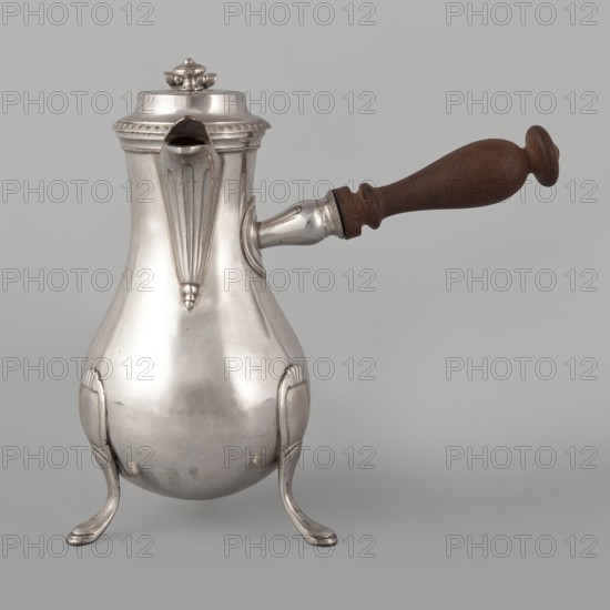 Coffee pot by F. Picard fl. ca. 1798–ca. 1809. Silver, c. 1798–1809. Paris, France. Vessel: height 46.0 cm; width 8.5 cm; depth 8.5 cm; weight 248.2 g., A reflective metal pitcher with a bulbous body and decorative raised ridges stands on a group of curved legs; it has a hinged lid with a small finial, a straight spout with a fluted decorative panel, and a horizontal cylindrical metal attachment connecting to a turned wooden handle. The visible colors are silver on the metal parts, brown on the wooden handle, and a neutral light gray background.