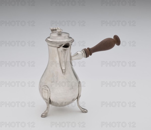 Coffee pot by F. Picard active ca. 1798–ca. 1809. Scrap-purchase; coffee pot, tableware item, jug. Made in Paris, France, ca. 1798–1809. Vessel; height 46.0 cm, width 8.5 cm, depth 8.5 cm, weight 248.2 g., A pear-shaped metal pot with a reflective silver surface stands on a group of three curved legs, each leg ending in a flattened foot; the pot has a short ornate spout and a hinged domed lid with a decorative finial, and a turned wooden handle attached to the side extending outward; visible colors include silver tones on the metal, brown on the wooden handle, and neutral gray and white in the background.