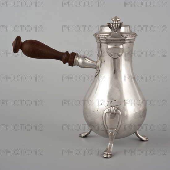 Coffee pot by F. Picard fl. ca. 1798–ca. 1809. Classification: vessel/coffee pot. Materials: metal implied, function: tableware/coffee service. Date: 1798–1809. Origin: Paris, France. Dimensions: height 46.0 cm; width 8.5 cm; depth 8.5 cm; weight 248.2 g., A silver metal kettle-like vessel with a rounded body on a group of curved legs, a hinged lid with a decorative finial, and a wooden handle extending from one side; visible colors include silver, brown, and gray.