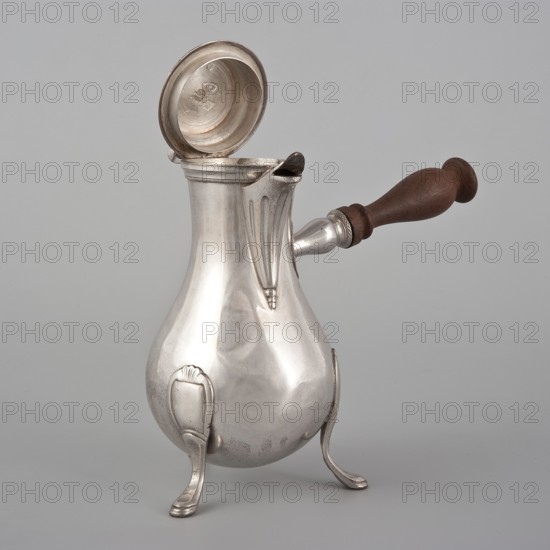 Coffee pot by Picard, F. fl. ca. 1798–ca. 1809. Classification: vessel. Materials: scrap - purchase?, function: coffee pot; category: tableware, jug. Date: 1798–1809. Place of origin: Paris, France. Dimensions: height 46.0 cm; width 8.5 cm; depth 8.5 cm; weight 248.2 g., A reflective metal pitcher with a bulbous body and a hinged lid opened upward, supported on a few curved legs, with a wooden handle extending from one side; visible colors include silver tones on the metal, brown on the wooden handle, and a pale gray background.