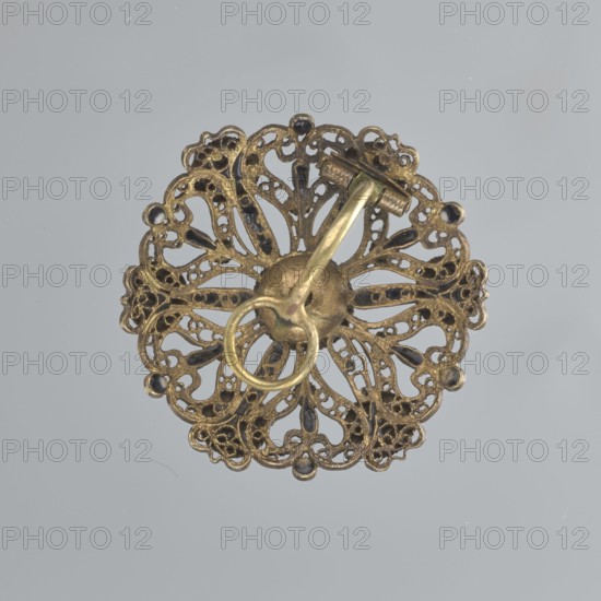 Earring, mid-19th century, Italy, jewelry, diameter 2.6 cm, A round, ornate metallic object with a filigree floral pattern in brass and darkened areas, showing a central raised dome and a curved pin-like attachment with a circular loop; the background is a smooth light gray.