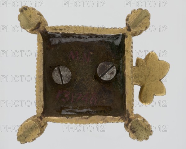 Toothpick holder, hedgehogs, animals, tassels; in the form of a hedgehog on a pad with tassels on the corners; 2nd quarter of the 19th century; Poland, possibly Warsaw; varia; height 3 cm, width 4.3 cm, depth 4.7 cm., A square metallic object with a scalloped gold-colored frame and a dark recessed center, showing a few circular silver-colored screw heads; the frame has rounded petal-like projections at the corners and a gold-colored clover-shaped handle on one side; colors visible include gold, dark brown, black, silver, and a bit of reddish tint in the recessed area.