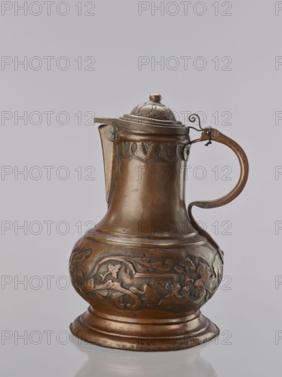 Jug. On a circular, stepped base, the body bulges in the lower part, decorated with a repoussé leafy twig and, at the rim, an eagle with spread wings. Above the two stepped areas is a neck with a spout. Repoussé leaves under the rim and along the rim. The hemispherical handle, fastened with rivets; the lid is hinged with a finger grip, arched, decorated with a leafy rosette and topped with a ball. Maker: Szewczykowski, Roman 1849–1901 creator attribution. 1st half of the 18th century, Poland. Vessel; height 39.5 cm, width 23.9 cm, depth 28.4 cm., A single metal pitcher with a hinged domed lid and a curved handle sits against a plain gray background; the pitcher is a warm brownish-bronze color with darker engraved decorative patterns around its bulbous lower body and a band of embossed motifs near the top, and the lid and spout area show similar engraved detailing; the handle has a small curled metal hook at its upper attachment and the base is stepped and slightly flared, all surfaces ...