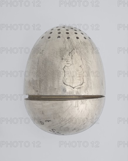 Salt cellar, scrap - purchase; spices vessel, salt vessel, spice vessels; 19th century; St. Petersburg, Russia; vessel; height 4 cm, width 3.1 cm, A metallic, egg-shaped object set against a light gray background, with a top half featuring a row of small round perforations and a horizontal seam where the two halves meet; the metal surface is worn and scratched with visible scuff marks and textured abrasions, showing areas of darker gray patina and lighter silvery highlights, and a faint irregular shaped impression on the upper half; overall colors visible are silver, light gray, and darker gray.