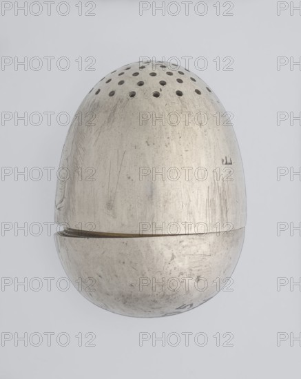 Salt cellar, scrap-purchase; spice vessel for salt; 19th century; St. Petersburg, Russia; vessel; height 4 cm, width 3.1 cm, A metallic egg-shaped object photographed against a pale gray background, with a few rows of round perforations near the top; the metal surface shows many scratches, scuffs, and worn areas giving a textured appearance, and there is a visible seam where the top and bottom halves meet; the colors visible are shades of silver, gray, and faint darker marks on the metal, with the background in light gray.
