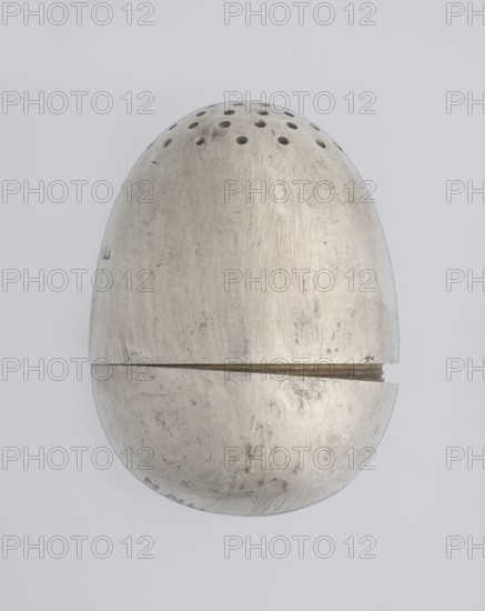 Salt cellar, scrap - purchase; spices vessel salt vessel, spice vessel; 19th century, St. Petersburg, Russia; vessel; height 4 cm, width 3.1 cm, A metallic, egg-shaped object with a dull silver-gray surface is centered on a pale gray background; the top half shows a series of small circular holes and darker scuff marks, while the body displays scratches, smudges, and areas of slightly darker tarnish; a horizontal seam separates the top and bottom halves, and the seam reveals a narrow strip of a warmer, brass-like color; the lower half mirrors the worn texture with additional scuffs and faint darker spots.