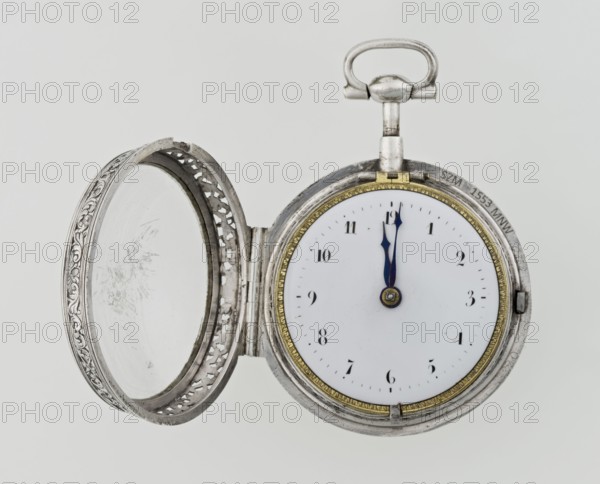 Pocket watch by Carl Willougby, 2nd quarter of the 18th century, London, England. Silver, partially openwork case with engraved ornament covering the entire surface: acanthus twigs and flowers, birds, two masks male and female, acanthus scrolls, fish-scale ornament, shells. Central circular reserve of acanthus twig, volutes and fish scales containing a bell. Glazed lid enclosed by an openwork frame decorated with a floral twig and a broken ribbon. Mechanism between two circular plates supported by columns, with a spindle escapement, a worm with a chain, and a balance drum; pocket watch with striking function. Gilded openwork crown engraved with an acanthus twig, combined with an openwork foot and a woman's mask. White enameled dial edged with a gilded knurled ribbon, hour markers in Arabic numerals, minutes marked with vertical lines; steel hands. Height 8 cm, width 5.5 cm, dial diameter 4.5 cm., A circular pocket watch with its ornate lid open, showing a white face and a pair of dark ...