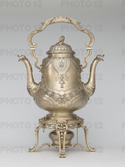 Kettle with warmer, by André Aucoc, goldsmith; tableware, kettle; 1887–1911; Paris, France; vessel; height 39 cm, width 27 cm, depth 17 cm, A large ornate metal vessel with a tall decorative handle and a matching lid sits on an elaborate stand, all rendered in a metallic gold color with subtle areas of darker gold shading; the vessel has a bulbous body with a pair of curved spouts on either side that end in stylized animal-head shapes, and the body is covered with raised floral and scrollwork motifs and repeating leaf designs; the hinged lid has a sculpted finial and ribbed decoration, and the handle is carved with flowing curves and leafy embellishments; the stand features curved legs with scroll feet, openwork ornamentation, suspended small chains, and a rounded burner-like component beneath the vessel, all sharing the same gold tones against a plain light gray background.