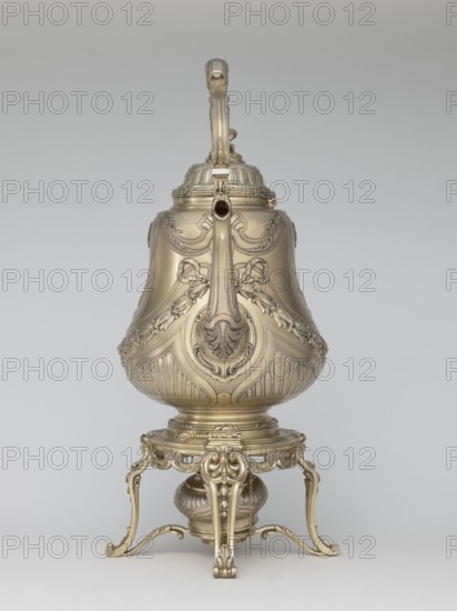 Kettle with warmer by André Aucoc, goldsmith; tableware item kettle, 1887–1911; France, Paris; vessel; height 39 cm, width 27 cm, depth 17 cm., A single ornate metal vessel with a handle and spout sits on an elaborate stand, all rendered in a metallic gold tone; the vessel has a bulbous body with carved decorative motifs including swags and leaf-like forms and raised patterned panels, a domed lid with a vertical handle extending upward, and a curved spout; the stand has scrolling legs, openwork aprons, and a rounded base element beneath the vessel, all sharing the same gold color against a neutral light gray background.
