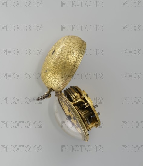 Pocket watch by Jacques Marcet fl. ca. 1725–ca. 1750, 2nd quarter of the 18th century. Gilded silver, almost spherical double case; enameled numerals on the dial. Cases decorated with plant decoration: inner case with flowers in a vase in a reserve formed by a ribbon that on the outer side forms heart-shaped loops with floral sprigs between them; a strip of plant-floral tendrils on the side of the case. Outer case has a flower sprig in a circular central reserve, surrounded by an interwoven ribbon and floral sprigs in the fields. Movement with openwork bow and Jacques/Marcet signature; inside both cases marked with number E. 4 unidentified. Engraved decoration stylized in a Middle Eastern style—possibly intended for the Turkish market. Possible French maker, though he may have worked in England if Huguenot. Timepiece; height 6.5 cm, width 5.5 cm, depth 4 cm., A decorative pocket watch case and partially exposed inner mechanism resting against a plain light gray background, the outer ca...