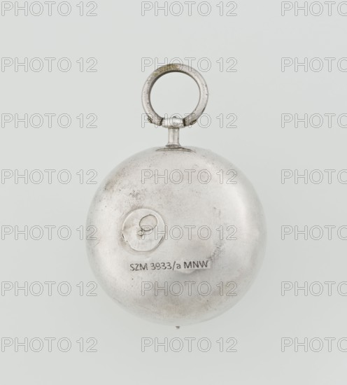 Pocket watch by John Bushman 1692–1720. Silver pocket watch in three cases: outer case covered with leather, rim decorated with studded silver rosettes; middle and inner cases plain. Underside of the inner case engraved with the casemaker's initial H and the number 3081. Transparent lid; silver champlevé dial with Roman numeral hour markers and Arabic minute markers in oval reserves on a matte background; central circular reserve with the watchmaker's signature on two semicircular plates reading BUSHMAN and LONDON; date window at the bottom. Steel hands with an openwork hour hand. Movement with a plate skeleton, spring drive, worm gear, and Gall chain; spindle escapement. Gilded lower plate with an openwork English-style bun in the form of a wreath filled with acanthus tendrils and an openwork grid, connected by a mascaron mask with an openwork bun foot. Hair adjustment is a rotating silver-plated dial with a scale I–VI. Engraved on the plate in italics: Jn Bushman 3081 / LONDON. Circa...