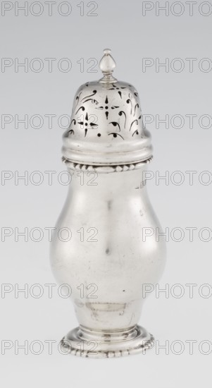 Powdered sugar bowl, powdered sugar bowl, maker: Harrod's Stores Ltd London seller, maker: Burbidge, Richard 1847–1917 goldsmith; scrap - purchase. Pear-shaped powdered sugar bowl on a circular profiled foot, with a domed openwork cover topped with a bowl. The edge of the foot and the top rim decorated with astargal. Openwork; sugar vessel; astargal ornament. Dish; height 15 cm, diameter 5.9 cm; weight 152 g. Date: 1913/1914. Place: London, England., A shiny metallic object shaped like a bulbous container with a removable domed top is centered against a pale gray background; the top has decorative pierced patterns and a small rounded finial, the rim where the top meets the body features a beaded edge, the smooth curved body shows subtle scratches and small dark marks, and the base is slightly raised with a ridged decorative edge. The visible colors are silver, pale gray, and small areas of darker gray.