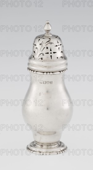 Powdered sugar bowl, pear-shaped on a circular profiled foot, with a domed openwork cover topped with a bowl. Edge of the foot and the top rim decorated with astargal. Openwork; sugar vessel; astargal ornament. Maker: Richard Burbidge 1847–1917, goldsmith. Date: 1913–1914. Materials/technique: likely silver; function: dish. Dimensions: height 15 cm, diameter 5.9 cm, weight 152 g. Place: London, England., A single metallic object with a shiny silver surface shaped like a rounded vase with a domed, perforated lid topped by a small finial; the lid shows decorative cutout patterns and the body has a smooth, curving profile with a beaded rim near the top and a fluted circular base with small raised bead details; visible surface wear and small scratches create subtle darker marks against the silver, and the background is a plain light gray.