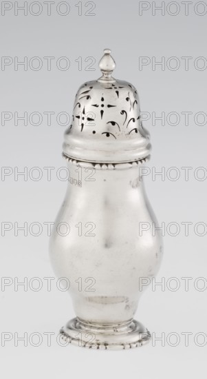 Powdered sugar bowl; pear-shaped powdered sugar bowl on a circular profiled foot, with a domed openwork cover topped with a bowl. Edge of the foot and the top rim decorated with astargal. Openwork; sugar vessel. Maker: Harrod's Stores Ltd London, maker's role: goldsmith Richard Burbidge 1847–1917. Date: 1913–1914. Place: London, England. Dish. Height: 15 cm; diameter: 5.9 cm; weight: 152 g., A single metallic object shaped like a bulbous container with a domed, pierced lid topped by a small finial is shown against a plain light background; the object has a smooth reflective surface with a few small blemishes and scratches, a decorative beaded band near the top and base, and visible cutout patterns on the lid; colors present include silver, gray, and subtle darker gray tones.