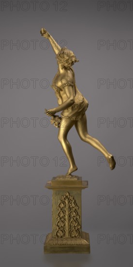 Candlestick, lyre and swans iconography, 19th century, Paris, France, lighting, height 54 cm, A gold-colored statue of a young person in a dynamic running pose mounted on a decorative gold-colored pedestal, the figure shown in profile with one arm raised and the other holding a small cluster of flowers, wearing a short garment with textured edges and a draped cloth across the back, hair styled with curls and a floral headpiece, the surface smooth and reflective with sculpted muscle and fabric details; the pedestal is ornamented with symmetrical floral reliefs and a textured base; background is a smooth gradient of gray.