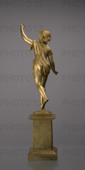 Candlestick, lyre iconographic, swans iconographic, 19th century, Paris, France, lighting, height 54 cm, A golden-colored small statue of a female figure standing on one foot atop a square pedestal, shown from the back; the figure has short wavy hair and a draped garment with textured fur-like detailing across the back and hip, an arm raised upward and the other relaxed by the side, with smooth limbs and subtle surface wear; the pedestal is also gold-toned with decorative molding near its base and a stepped top, all set against a neutral gray background.