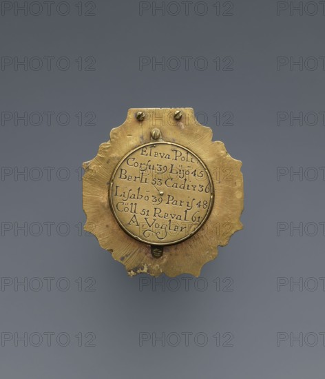 Equatorial sundial by Andreas Vogler ca. 1730–1800. Circular Augsburg-type sundial with a wavy edge; inside a compass with a hinged hour circle and an arched hinged arm marked with geographical latitudes. Engraved decoration on the rim with C-shaped sections and stylized acanthus leaves. Engraved on the underside of the compass case: Eleva. Poli. / Corfu 39 Lyon 45 /' Berlinn 53 Cadiv 36 / Lisabon 39 Paris 48 / Colln 521 Reval 61. Made in Augsburg, Germany, third quarter of the 18th century; measuring instrument., A small metallic object with a decorative scalloped edge, primarily golden in color with areas of darker tarnish, sits against a smooth gray background. The object has a circular central plate set into the scalloped form, with a few small raised rivets near the top and bottom and subtle radial tool marks on the outer surface. The central plate appears slightly recessed and shares the same golden tone but with a smoother texture; there are traces of darker spots and worn areas...