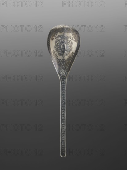 Baroque silver travel spoon with a teardrop-shaped scoop decorated on the reverse with the Korczak coat of arms in a decorative cartouche, with the SL monogram on the sides; stylized plant twig decorations; all decorations in niello; the inside of the scoop gilded. Traditional attribution of niello-painted artefacts to the centre in Lviv is not necessarily correct; niello was also used in other centres of the Polish–Lithuanian Commonwealth at that time. Despite the very good quality of the decoration, its value is enhanced by the preserved case, undoubtedly made for it; very few cases without spoons have survived. 1st half 18th century, Poland possibly Lviv. Cutlery. Height 22.9 cm, width 5.6 cm., Coat of arms: Korczak., A single ornate spoon shown against a gradient gray background, with a rounded bowl and a long narrow handle; the spoon surface features intricate decorative patterns and motifs, including scrollwork and a central emblem-like design in darker tones against a lighter me...