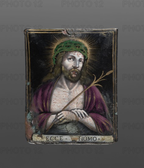 Plaque with a depiction of Christ - Ecce Homo, painted enamel, Ecce homo iconographic. Rectangular, slightly convex plaque with a depiction of Christ in a bust, wearing a crown of thorns, holding a baton, marks of scourging on his chest, and a purple robe on his shoulders. The whole set in a double painted gold frame. At the bottom, on a strip of white enamel, the inscription ECCE HOMO. A hole and enamel chips in the upper edge, at the bottom in the left corner and in the middle, as well as traces of old additions. Contre-email brownish-reddish. Early 17th century, Limoges, France. Plaque height 8.8 cm, width 7 cm., A painted rectangular panel showing a bust of a man with long brown hair and a beard wearing a green crown-like headpiece and a purple robe; his skin is pale with short red marks across his chest and forehead, and his expression appears solemn as he looks slightly upward and to the side. He holds a slender brown twig or reed across his folded hands, and a radiating golden h...