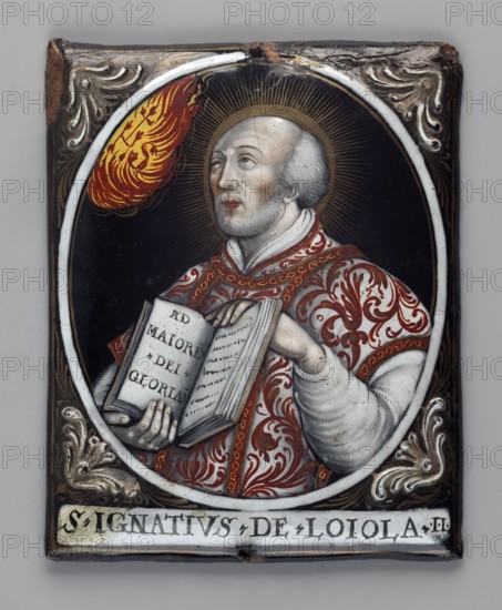 Rectangular enamelled plaque with a medallion image of Saint Ignatius of Loyola founder of the Jesuit Order in a richly decorated dalmatic, his head haloed, holding an open book inscribed AD MAIORE DEI GLORIAM. He gazes upward at a cloud of flames inscribed HS, tears streaming from his eyes. The image is framed by a circular band with plant motifs in the corners palmette. Below is the inscription S IGNATIUS DE LOIOLA II. 4th quarter of the 17th century, Limoges, France. Height 10 cm, width 8 cm. Maker: Jacques Laudin ca. 1663/8–1729, enameller., A painted oval portrait on a rectangular panel shows a bearded older man with pale skin and gray hair wearing a richly patterned red and white robe and a white garment underneath, holding an open book with visible pages; a golden halo with radiating lines surrounds his head and a flaming red and yellow shape appears near the top left of the oval; the background inside the oval is black, and the surrounding frame area is dark brown with decorati...