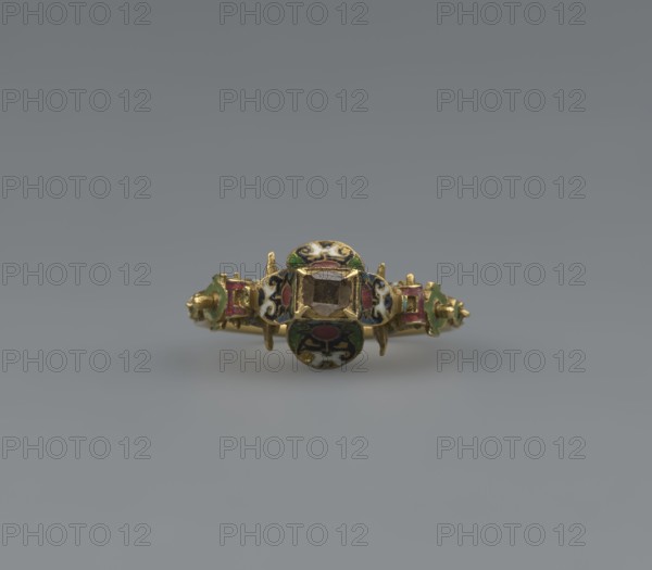 Women's ring, 19th century, Poland, jewelry, height 2.4 cm, width 2.1 cm, A small ornamental ring is centered against a smooth gray background, the ring made of gold with a central faceted stone held in a square bezel and flanked by decorative round and rectangular enamelled panels; the enamel shows colors including green, red, black, white, and blue, and the metal has a yellow-gold tone.