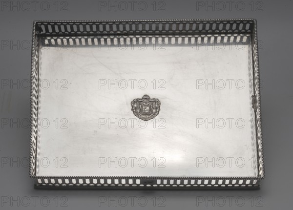 Tray with a gallery, Sponholtz, Friedrich Wilhelm 1730–1789 goldsmith. Rectangular, surrounded by an openwork gallery motif of semicircles with elongated hexagons between them, with a pearled edge. On one of the longer sides, in the middle, a smooth reserve with goldsmith's marks. In the center of the mirror, a relief plaque with the Czartoryski family coat of arms is soldered on, beneath the mitre, with the motto and holders on a paludamentum. The bottom of the tray is made of brass sheet, thickly silver-plated on both sides technique uncertain—probably cold silver leaf plating, argent haché. The plaque with the Czartoryski coat of arms is secondary, added in France in the second quarter of the 19th century; the bottom may also have been replaced at that time. The placement of goldsmith's marks on the openwork gallery, with the only reserve, supports its originality. Date: 1770s. Place: Gdansk, Royal Prussia, Poland. Vessel. Height 3.5 cm; width 27.5 cm; depth 22 cm; weight 1170 g., A...