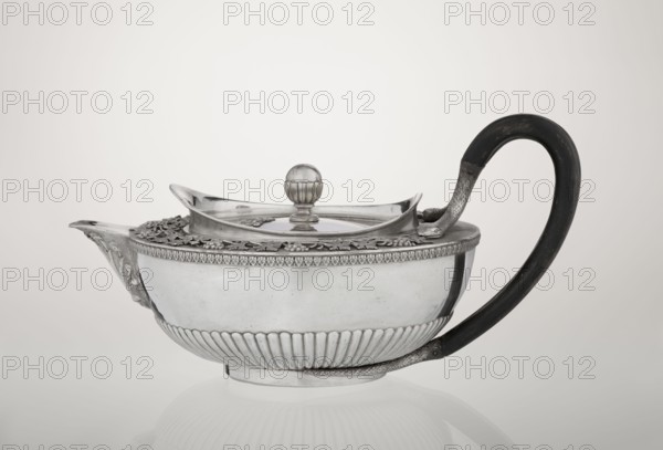 Teapot, Rundell Bridge & Rundell fl. ca. 1788–1845 goldsmith's firm, Scott, Digby & Smith, Benjamin fl. 1802–1807 goldsmiths; vines, snake iconography; Pogon Ruska coat of arms; purchase provenance; tea vessel; coats of arms; tea vessel; rank crowns; princely mitre heraldry; mottos heraldry; paludamentum heraldry; acanthus leaves ornament; clasp; labry heraldry. Hemispherical, on a low cylindrical pedestal; body decorated in lower part with radial curls, upper edge with a band of acanthus leaves; hinged lid surrounded by a raised collar with an applied vine branch with clusters; double handle of blackened wood set in caps upper ones shaped as snake heads, lower ones as tails; the Czartoryski coat of arms applied on a paludament with labry and the motto Badz co sie jest. 1803/1804, London, England, Great Britain. Vessel; height 13 cm, width 24.6 cm, depth 17.2 cm; weight 1002 g., A metallic teapot with a rounded body and decorative fluted lower band sits on a reflective surface, featuri...