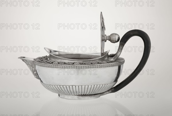 Teapot, Rundell Bridge & Rundell fl. ca. 1788–1845 goldsmith's firm, Scott, Digby & Smith, Benjamin fl. 1802–1807 goldsmith's firm; vines, snake iconography; Pogon Ruska coat of arms; purchase provenance; tea vessel; coats of arms; tea vessel; rank crowns; princely mitre / heraldry; mottos heraldry; paludamentum heraldry; acanthus leaves ornament; clasp; labry heraldry. Hemispherical, on a low cylindrical pedestal; body decorated in the lower part with radial curls, with an upper band of acanthus leaves; hinged lid surrounded by a raised collar with an applied vine branch with clusters; double handle of blackened wood set in caps upper caps shaped as snake heads, lower as tails. The Czartoryski coat of arms applied on a paludament with labry and the motto Badz co sie jest. 1803/1804, London, England Great Britain. Vessel; height 13 cm, width 24.6 cm, depth 17.2 cm, weight 1002 g., A silver teapot with a polished metallic body and ornate decorative rim sits on a reflective surface, feat...