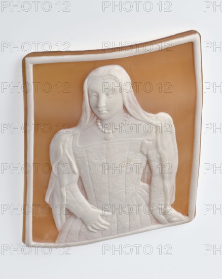 Cameo with a portrait of Bona Sforza d'Aragona 1494–1557, wife of Sigismund I the Old; portrait of a young woman in 3/4 length with her head turned slightly to the right and her gaze directed at the viewer, wearing a veil covering her shoulders, a dress with a square neckline, flat bodice, belted waist, pleated skirt and narrow sleeves decorated at the top with a roller; she holds her right hand at the height of her belt, left hand lowered revealing her veil. Portrait of Bona Sforza d'Aragona 1494–1557, after a miniature, 2nd half of the 19th century; Italy, Torre del Greco; gemma, bas-relief; height 5.1 cm, width 4 cm., A relief plaque showing a carved figure of a woman in a dress and draped shawl set against a rectangular background; the figure and frame are a creamy off-white color with a warm tan background, and the woman wears a beaded necklace and has long hair, with detailed patterns on the bodice and skirt and visible hands resting at her waist.