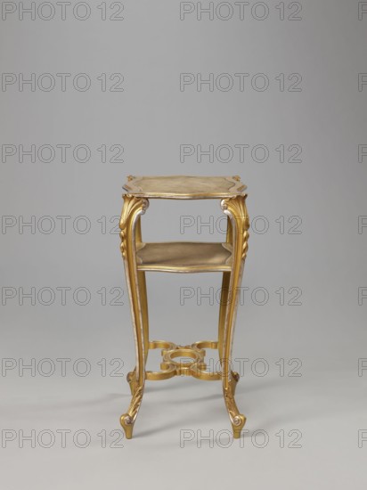 Side table, equipment of representative buildings of the Republic of Poland 1918–1939, plant decoration, acanthus ornament, volutes, neo-rococo style, 3rd quarter of the 19th century, Warsaw, furniture, table; height 77.3 cm, width 50 cm, depth 40 cm, A tall narrow wooden stand with a gilded finish and gold and beige tones, featuring an ornate top surface with curved edges, a lower shelf, and four cabriole legs with carved decorative motifs and scroll feet; a decorative stretcher with curved shapes connects the legs near the base, and the background is a smooth neutral gray.