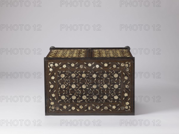 Cabinet, plant decoration, columns, rosettes, early 20th century, India, Europe, piece of furniture, storage piece; height 46.2 cm, width 63 cm, depth 43 cm, A rectangular dark wooden chest with ornate floral inlay sits against a light gray background; the front and top surfaces display a repeating pattern of floral motifs and curling vines in pale cream and gold tones set within thin brown borders, and the chest has small rounded dark handles at the top corners.