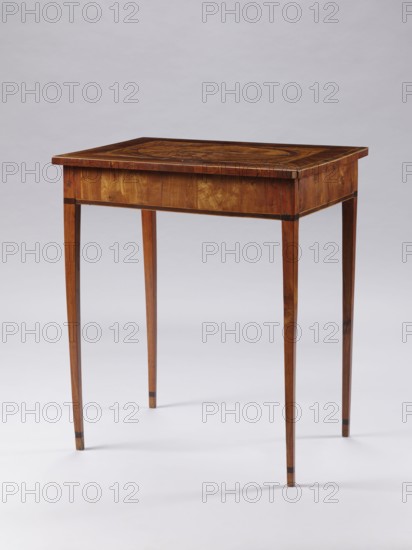 Table, late 18th century, Poland, Classicist rectangular inlaid table supported by four slender, angular, converging legs. On the tabletop, a rectangular field framed by a wide border with light veining, containing an inscribed oval bordered by a wide ribbon and veining. Inside the oval: a seaside landscape with a palm tree on the left, a castle on the right, and two men in Eastern costume standing at a round table with dishes and fruit. Between the S-shaped legs of the table are two bundles. At the bottom of the composition is a cartouche with the initials JJ possibly TT. Figures in Eastern costume, palm trees, seascapes, sailing ships, monograms. Furniture — table. Dimensions: height 73.5 cm, width 63.7 cm, depth 46.3 cm., A wooden table with a rectangular top and slender tapered legs standing on a light surface against a pale background. The table shows a warm brown wood grain with darker brown inlaid details on the tabletop and darker accents near the upper and lower parts of the l...