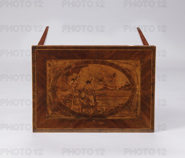 Table, figures in Eastern costume, figures against a landscape, palm trees, seascapes, sailing ships, monograms. A Classicist rectangular inlaid table, supported by four slender, angular, converging legs. On the tabletop a rectangular field framed by a wide border with light veining, containing an inscribed oval bordered by a wide ribbon and veining. Inside the oval is a seaside landscape with a palm tree on the left, a castle on the right, and two men in Eastern costume standing at a round table with dishes and fruit. Between the S-shaped legs are two bundles. At the bottom of the composition is a cartouche with the initials JJ or TT. Late 18th century, Poland, furniture, table. Dimensions: height 73.5 cm, width 63.7 cm, depth 46.3 cm., A rectangular wooden panel with a warm brown finish features an oval central inlay depicting two figures standing near a shoreline with a small boat and distant buildings; the panel shows grain patterns and darker brown border inlays, and the overall s...