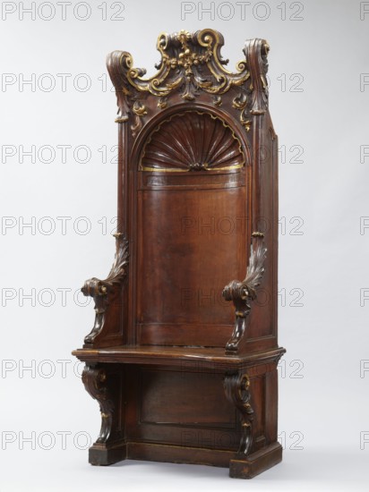 Church throne armchair, carved, with two console supports for the board seat and a high rectangular backrest in the form of an aedicula topped with a volute top. Supported on a platform cut out in the shape of the letter U. The supports, sides, and lower part of the back have a frame structure. The seat has a concave outline and a profiled rim, lifting in the middle, on hinges. The aedicula in the backrest is made of two parts, in the form of a shell at the top, framed by a profiled cornice. The lower side walls arch into the armrests. The upper part of the seat supports, armrests, and side pinnacles are carved with volutes made of acanthus leaves. The aedicule shell rim and the volutes in the finial are gilded. Shells, acanthus ornament, plant decoration; Baroque style; church furnishings; mid-18th century, Italy. Piece of furniture seating; height 201.5 cm, width 81 cm, depth 59 cm., A tall ornate wooden chair or bench with a high carved back, featuring a semicircular shell motif at ...
