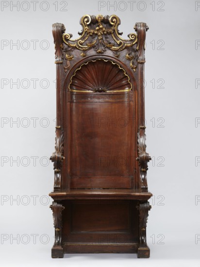 Church throne armchair, carved, mid-18th century, Italy. Seating piece furniture with two console supports for the board seat and a high rectangular backrest in the form of an aedicula topped with a volute top. Supported on a platform cut out in the shape of the letter U. Supports, sides, and lower part of the back have a frame structure. Seat has a concave outline with a profiled rim, lifting in the middle on hinges. The aedicula in the backrest is two-part, with a shell at the top framed by a profiled cornice. Lower side walls arch into the armrests. Upper seat supports, armrests, and side pinnacles are carved with volutes formed of acanthus leaves. Aedicula shell rim and volutes in the finial are gilded. Ornament: shells, acanthus, volutes; style: Baroque. Height 201.5 cm, width 81 cm, depth 59 cm., A tall carved wooden chair with a high back featuring an arched shell motif near the top and ornate scrollwork and foliage carvings along the crest and sides, with visible gilded highlig...