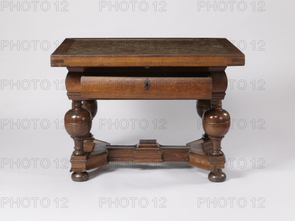 Stock exchange table, provenance unknown, Baroque style, stone tops, rectangular. Rectangular stock exchange table with a stone top enclosed in a wooden frame and a drawer in a high frame, supported by four turned legs joined with an H stretcher made of profiled beams. Baluster legs with massive balls in the upper section, terminating at the bottom with flattened balls. In the central section of the stretcher, a rectangular extension with a pinnacle not preserved. Reinforcing parquetry under the top. Applied drawer bottoms with slides. Stone top polished only on the upper surface. Drawer lock plate in the form of a cartouche topped with a lily. Steel mortise-and-slip double-bolt lock. 4th quarter of the 17th century, possibly Royal Prussia. Furniture; table. Height 88.5 cm, width 121.3 cm, depth 90.4 cm., A wooden table with a rectangular top and a recessed central surface, supported by a pair of thick turned legs on each side connected by a shaped stretcher base, showing rounded bulbo...
