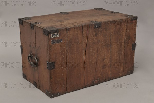 Cabinet, Baroque period, 2nd quarter of the 17th century, Gdansk. A cuboid cabinet with a boarded body fitted with steel decorative strips, closed with double doors. Framed doors with single panels in the form of convex coffers glued at the mitre from richly profiled strips. Steel closing strip with a wavy outline; rectangular and trefoil-shaped angular fittings on the edges of the body, punched and fastened with headers. Inside, sixteen drawers arranged in five rows: two in the top row, four in each of the two middle rows, and three in the bottom row. Drawer faces framed with profiled strips; the three drawers in the middle row feature numerous internal divisions. Walls connected with exposed diagonal dovetails; back joined to top and sides with dowels. Drawers with exposed diagonal dovetail joints and nailed bottoms. Oval side handles and round drawer handles with rosette-shaped plates. Steel strap hinges with a wavy outline; both door leaves have steel mortise-and-apply locks with a...