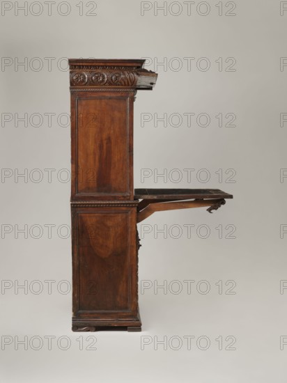 Cabinet, Cuboid cabinet with a two-winged base and an upper section with a folding flap, topped by a prominent carved cornice. Base divided by three vertical bands of rosettes with mascarons at the top; door panels framed by moldings carved with a cymatium motif; turned wooden knobs on doors. Base plinth molding carved with a cymatium motif. Low board legs carved with S-shaped forms. Flap surrounded by rosette ornament; lower section of cornice slightly convex, carved with rosettes and a central coat of arms. Behind the hinged lower section of the front cornice accessible after opening the flap is a recess. Behind the folding flap are four single-leaf cabinets and 21 drawers. Doors of two cabinets feature aedicules with solid gilded figures of men in togas. Interiors of cabinets and drawers lined with red marble-pattern wallpaper. Inside the base is a single shelf. Steel eyelet-type door hinges. Flap lock a single-bolt mortise-and-apply type with a steel plate shaped like a bird’s tail...