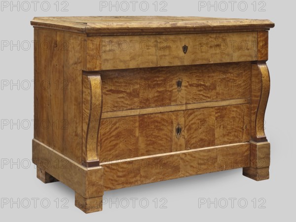 Chest of drawers, repossession provenance; Biedermeier style. Rectangular four-drawer chest with a wooden top with profiled edge sima, platka, and quarter round, on block legs; veneered with wavy birch. Front corners framed in the central section by volute consoles veneered with burl bird's-eye maple?. The upper and lower drawers extend out, the lower one set in the plinth. On the faces of the three upper drawers are inlaid dark disc-shaped lock plates. Backs are board, chamfered, recessed from below. Locks of the three upper drawers are applied-mortise, steel, single-bolt. Dated 1830–1840. Central Europe, possibly Poland. Piece of storage furniture. Height 85.5 cm; width 119 cm; depth 61.2 cm., A wooden chest of drawers with a warm brown and golden grain finish is shown against a pale gray background; the piece has a rectangular top with a slightly projecting molded edge, a straight front with two curved vertical carved supports on either side, and a plinth base with short block feet....