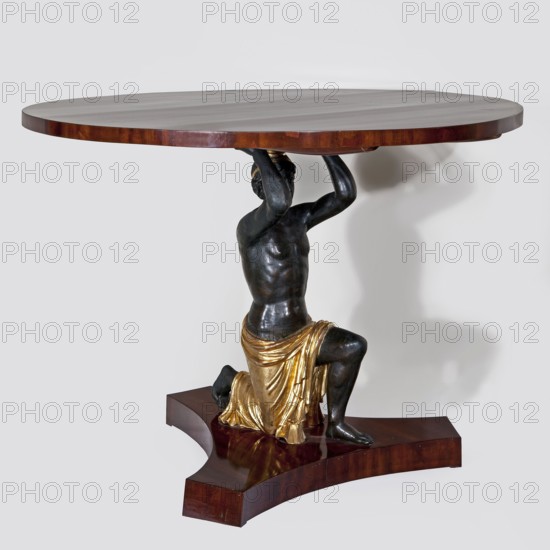 Table, empire style, furnishings of representative buildings of the Republic of Poland 1918–1939, male figures, 1816–1825, Warsaw, Vienna, furniture, table, height 81 cm, diameter 110 cm, A round wooden tabletop in a warm brown tone sits atop a sculpted dark figure serving as the table's support; the figure has a dark metallic finish and is kneeling with arms raised to hold the tabletop, wearing a draped cloth with a bright gold color, and resting on a glossy wooden base matching the tabletop's brown hue; the background is a light neutral color.