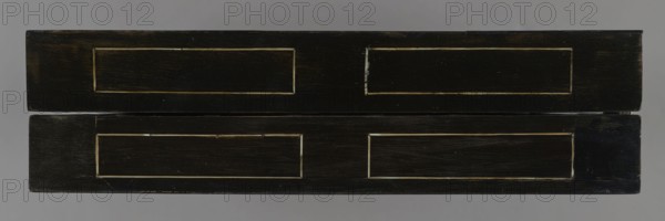 Chess, mill and backgammon box;, games; flower vases; chess; ; plant decoration; baroque style; landscapes; backgammon; animals; birds; checkers; 1680s; France; furniture; game furniture; height 9 cm; width 37 cm; depth 32.8 cm, A horizontal view of a rectangular object with two stacked dark wood panels, each panel showing a recessed rectangular inset; the wood appears black with visible grain and worn edges revealing lighter brown tones, and there are thin pale lines outlining the recessed areas; the background is a neutral gray.