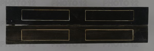 Chess, mill and backgammon box; maker, games; flower vases; chess; ; plant decoration; baroque style; landscapes; backgammon; animals; birds; checkers; 1680s; France; furniture; equipment; game furniture; height 9 cm; width 37 cm; depth 32.8 cm, A rectangular wooden box with a dark black finish shown from the top, featuring two long panels on the lid and two matching panels on the base separated by a narrow horizontal gap; each panel has a recessed rectangular border highlighted by a lighter beige or tan trim, and the black surfaces show signs of wear with scuffs and scratches; the background is a flat medium gray.