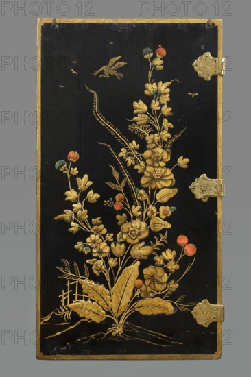 Cabinet, origin unknown, chinoiserie decoration with flowers, birds, trees, rocks, genre scenes against a landscape background, buildings, Chinese figures, bridges, geometric ornament, plant decoration; circa 1725, possibly Dresden; furniture storage cabinet; height 76 cm, width 85.5 cm, depth 41.5 cm., A tall rectangular panel with a black background framed by a narrow golden border, decorated with a vertical arrangement of ornate floral motifs painted in gold with touches of red, green, and blue on some round buds, a few delicate leaves, and several stylized blossoms clustered along sinuous stems; a few small flying birds are depicted near the top, and there are two ornate metal hinges with embossed decoration along the right edge.