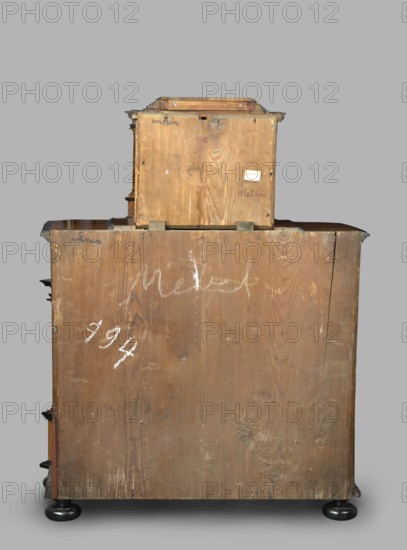 Cabinet, baroque style, columns, birds, early 18th century, Southern Germany, possibly Augsburg, piece of furniture storage piece, height 114 cm, width 92 cm, depth 41 cm, A large wooden box-like structure with a smaller wooden box stacked on top, both showing visible wood grain and a worn, rough surface in brown tones; a few white scuff marks and smudges appear on the wood, including some chalky white marks; metal corner brackets and small metal fasteners are visible at edges, showing a darker metallic color; the assembly rests on round black feet with a glossy finish, and the background is a flat neutral gray.