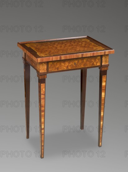 Table, classicism style, geometric ornament, rosettes ornament. Rectangular classicist table, inlaid, supported by four straight, converging legs. Leg surfaces decorated with rose-filled fields, edged with light veining. Leg cubes with inlaid rosettes. Straight frame repeating the outline of the top, with a drawer on the longer side, inlaid with the top into a cube in perspective. The top is bordered with a straight edge creating a kind of gallery. Semi-mortise, flush, single-bolt lock. Late 18th century, Central Europe. Furniture, table; height 71 cm, width 39.5 cm, depth 52.5 cm., A wooden table with a rectangular top featuring intricate geometric marquetry in warm brown and golden tones, a darker brown border along the top edge, slender tapered legs with vertical lighter wood inlays, a shallow apron with matching geometric inlay and small carved floral motifs at the corners, and an overall finish showing polished wood grain in shades of brown, amber, and tan against a neutral gray b...